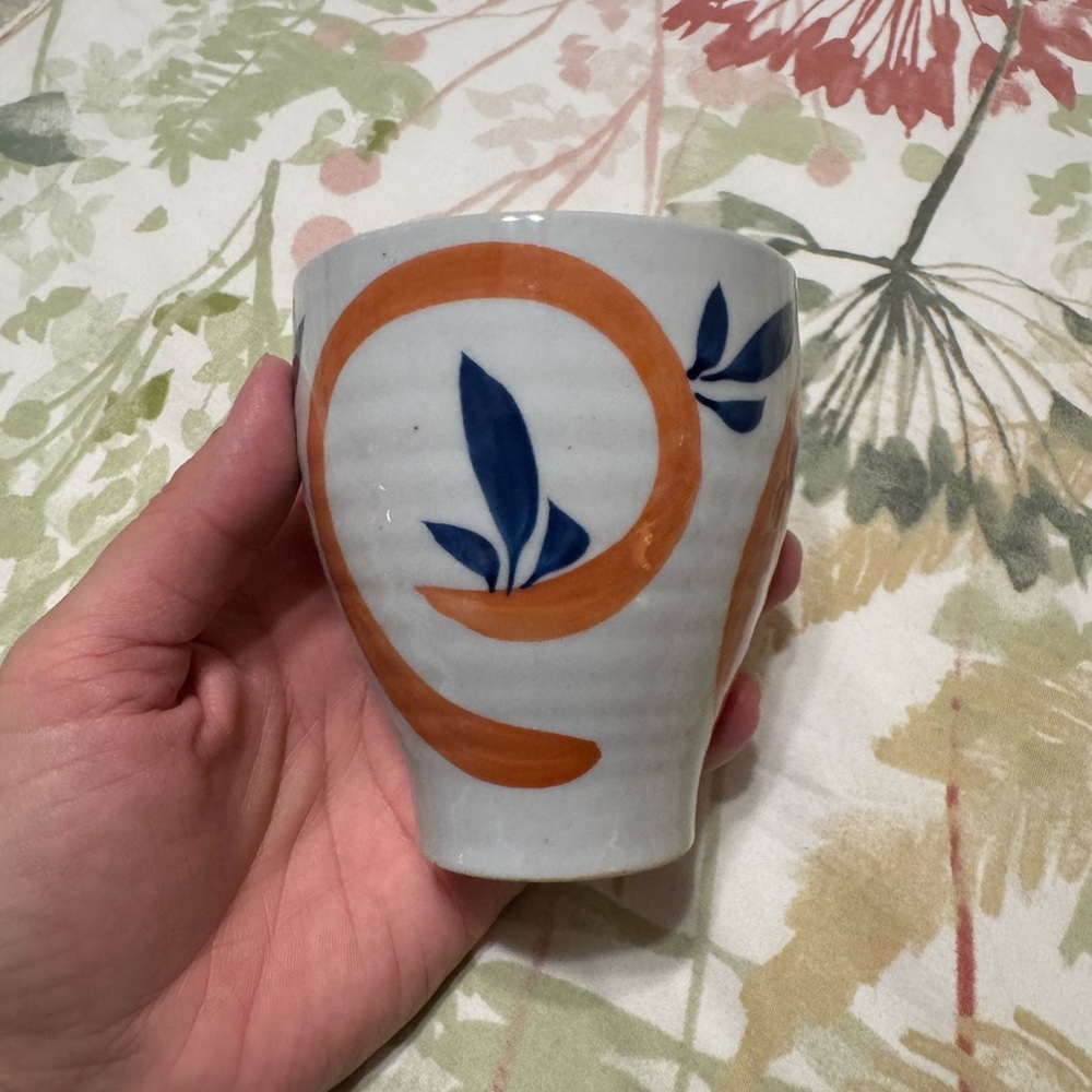 Elegant Ceramic Cup with Orange and Blue Accents